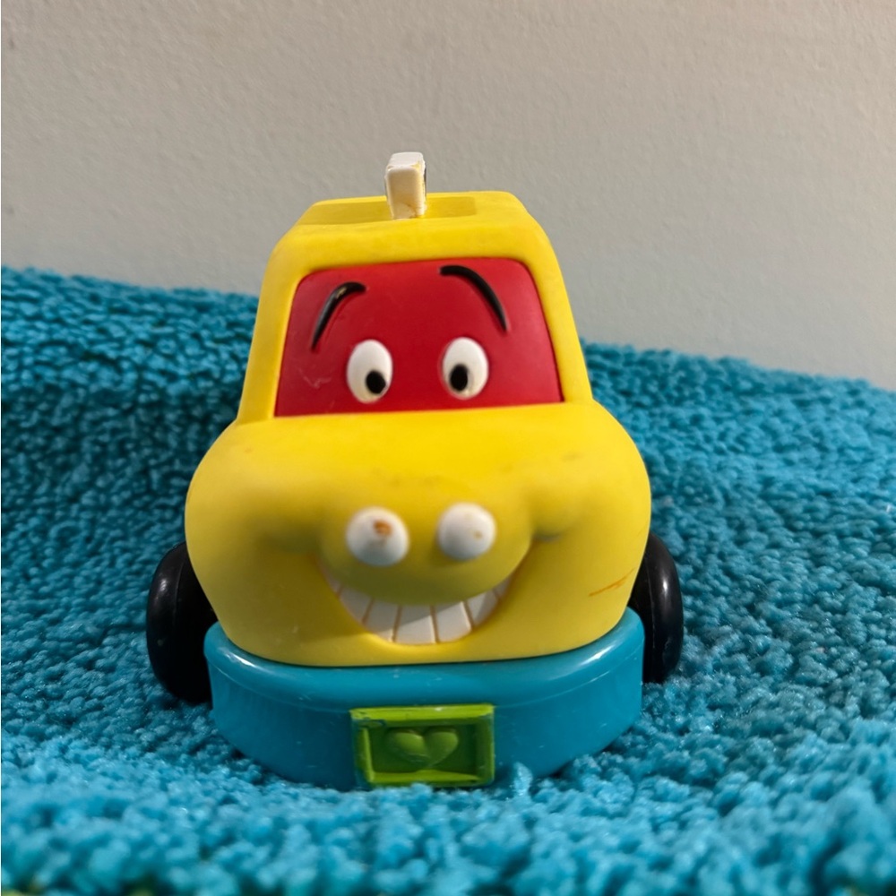 Cheerful Yellow and Red Toy Car with Smiling Face